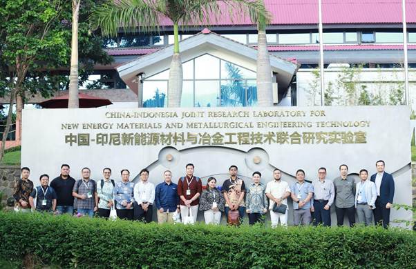 A group of people standing in front of a sign

AI-generated content may be incorrect.