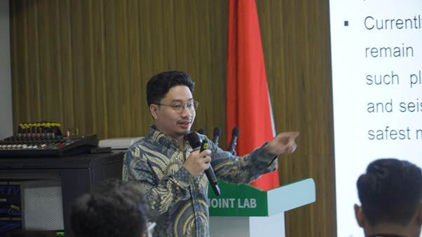 A person standing at a podium with microphones

AI-generated content may be incorrect.